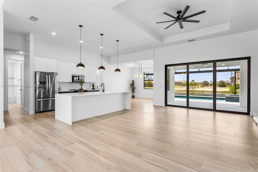 EXPANSIVE LIVING ROOM features 14-foot cove ceiling & offers views of LANAI & SALTWATER CANAL! EXPANSIVE LIVING ROOM features 14-foot cove ceiling & offers views of LANAI & SALTWATER CANAL!