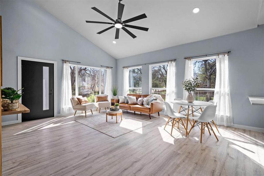 Living area with recessed lighting, light wood-style flooring, vaulted ceiling, and ceiling fan Living area with recessed lighting, light wood-style flooring, vaulted ceiling, and ceiling fan