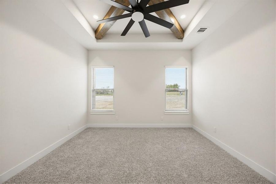 Vaulted ceiling featuring exposed wood beams and a large ceiling fan
