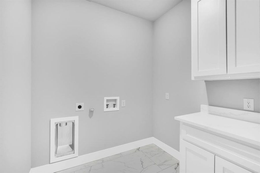 Laundry area featuring electric dryer hookup, hookup for a washing machine, gas dryer hookup, and cabinets