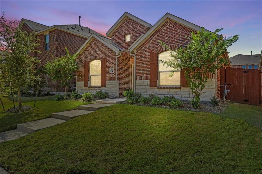 View of front facade featuring stone siding and brick siding View of front facade featuring stone siding and brick siding