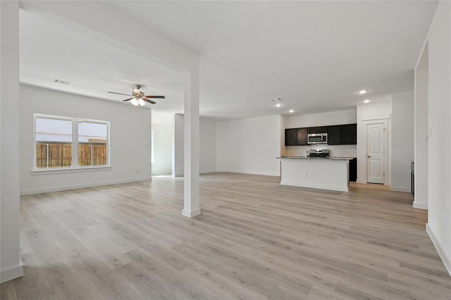 Unfurnished living room with light wood finished floors, recessed lighting, and ceiling fan