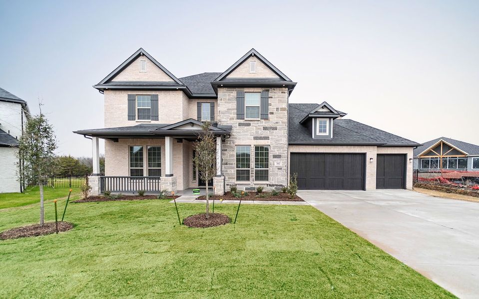 Front exterior of a new home in Heath Golf & Yacht Club, Heath, TX, highlighting curb appeal (Image 1). Front exterior of a new home in Heath Golf & Yacht Club, Heath, TX, highlighting curb appeal (Image 1).