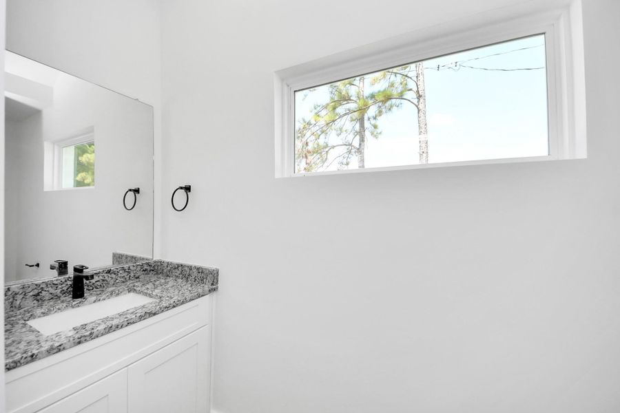 Downstairs half bath with window features lots of natural light