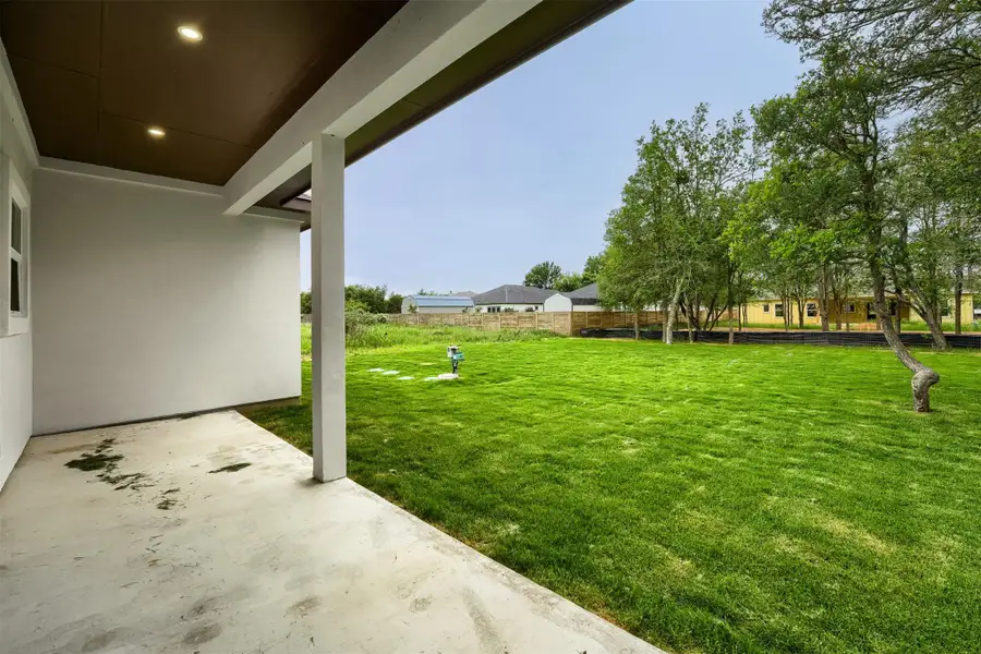 Spacious covered patio overlooking a peaceful oversized yard
