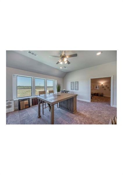 Rec room with ceiling fan, light colored carpet, and lofted ceiling