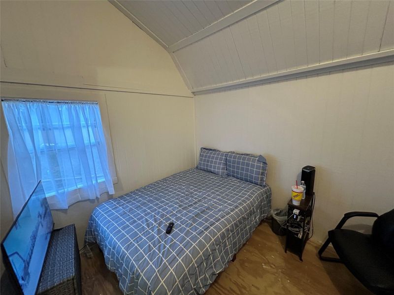 Bedroom with lofted ceiling and wooden ceiling
