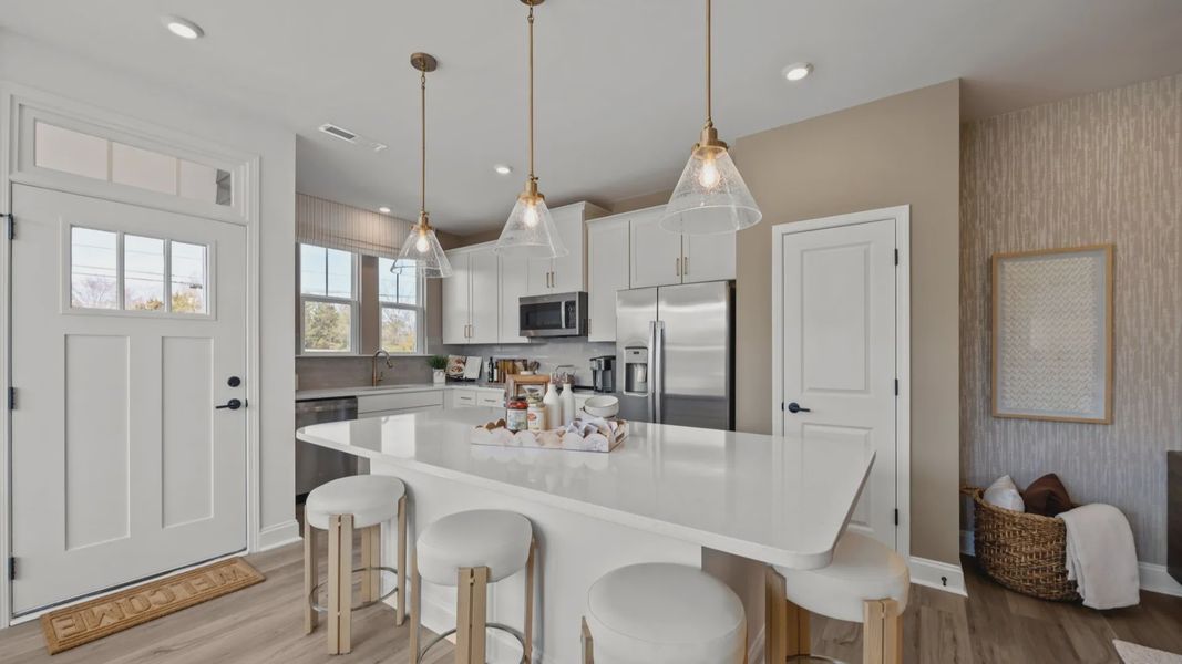 The Rochester Plan by DRB homes kitchen with island and modern features in Charlotte, NC.