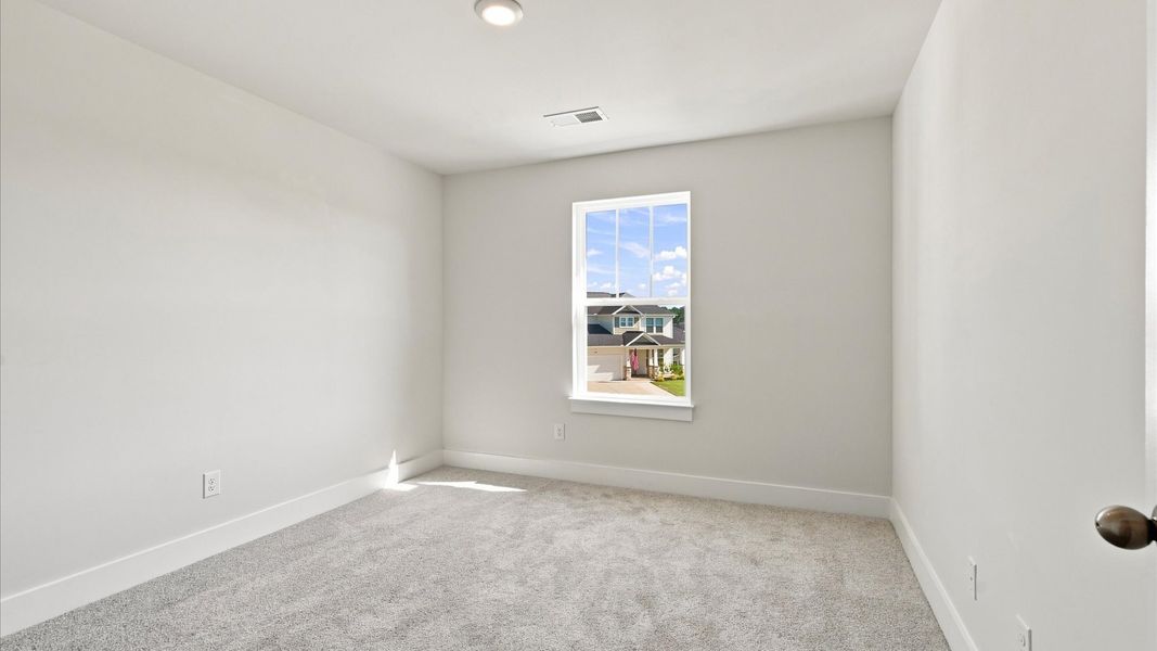 Accomplished design in this restful bedroom featuring plush carpet and oversized window views