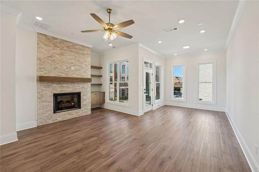 Open family/living room space features a cozy and warm Sunroom space that gives you access to your private back deck.  Perfect space to enjoy a lazy morning.  Image is of a previously built Chamberlain Plan.