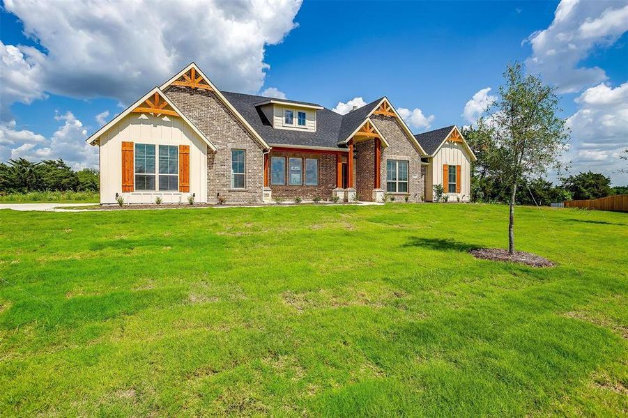 Craftsman-style home featuring a front yard