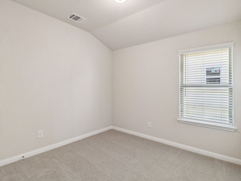 Guest bedroom in the Callaghan floorplan at a Meritage Homes community.
