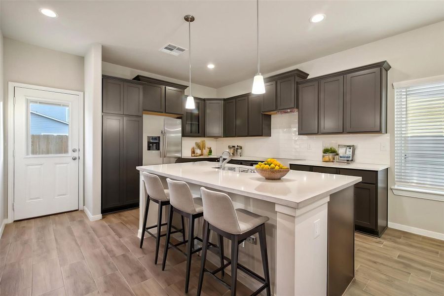 The spacious island offers extra seating that is perfect for a quick meal or casual dining.