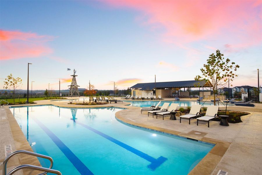 Pool at dusk with a patio, a community pool, and fence