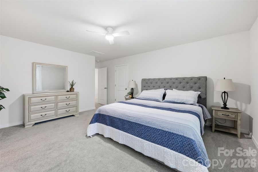 primary bedroom, walk in closet, ensuite with walk in shower, water closet, and linen closet.