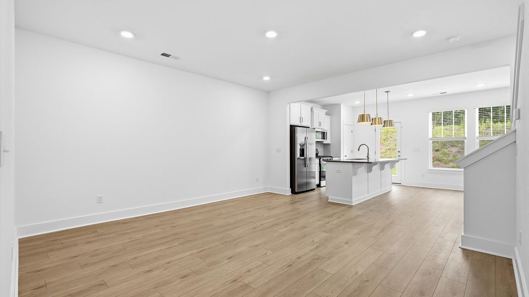 Hardwood flooring and high standards define this vibrant family room ideal for everyday living by DRB Homes Hardwood flooring and high standards define this vibrant family room ideal for everyday living by DRB Homes