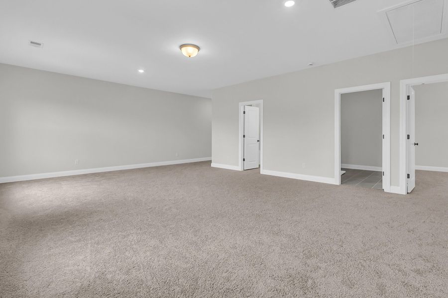 Spacious, unfurnished interior of a new home in Tidewater at Lakes of Cane Bay, Summerville (Image 32).