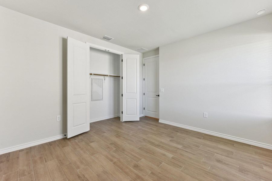 Unfurnished bedroom featuring recessed lighting, light wood-type flooring, and a closet