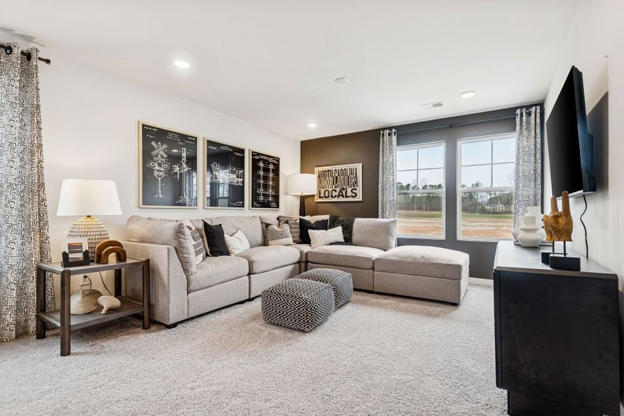 A living room with a large window. A living room with a large window.