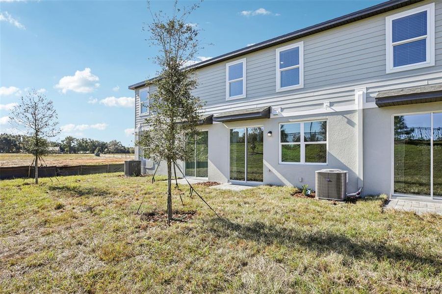 Exterior details and patio area of a home in The Reserve at Hammock Oaks Townes, Lady Lake (Image 3).