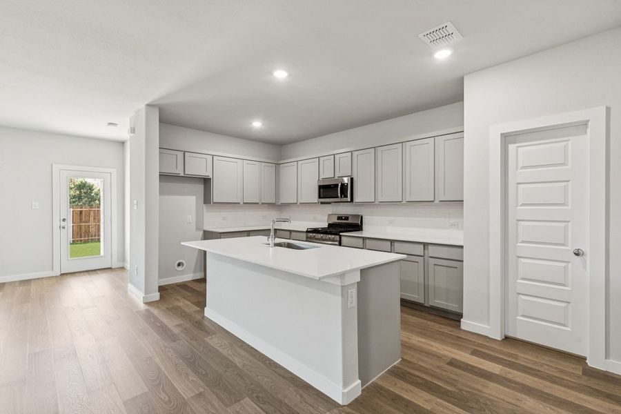 Kitchen in the Oscar home plan by Trophy Signature Homes – REPRESENTATIVE PHOTO Kitchen in the Oscar home plan by Trophy Signature Homes – REPRESENTATIVE PHOTO