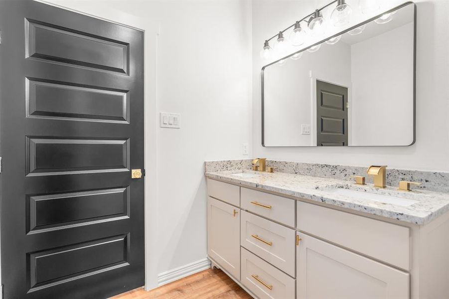 Hall bathroom with tiled shower and dual sinks Hall bathroom with tiled shower and dual sinks
