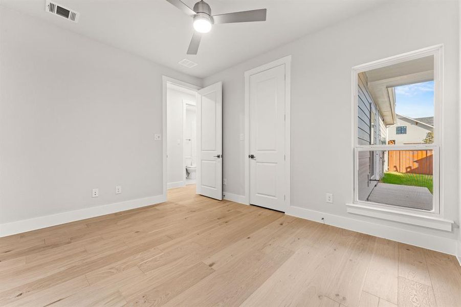 Unfurnished bedroom featuring light wood-type flooring and ceiling fan