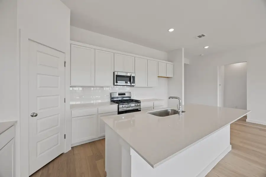 Kitchen in the Colorado home plan by Trophy Signature Homes – REPRESENTATIVE PHOTO Kitchen in the Colorado home plan by Trophy Signature Homes – REPRESENTATIVE PHOTO