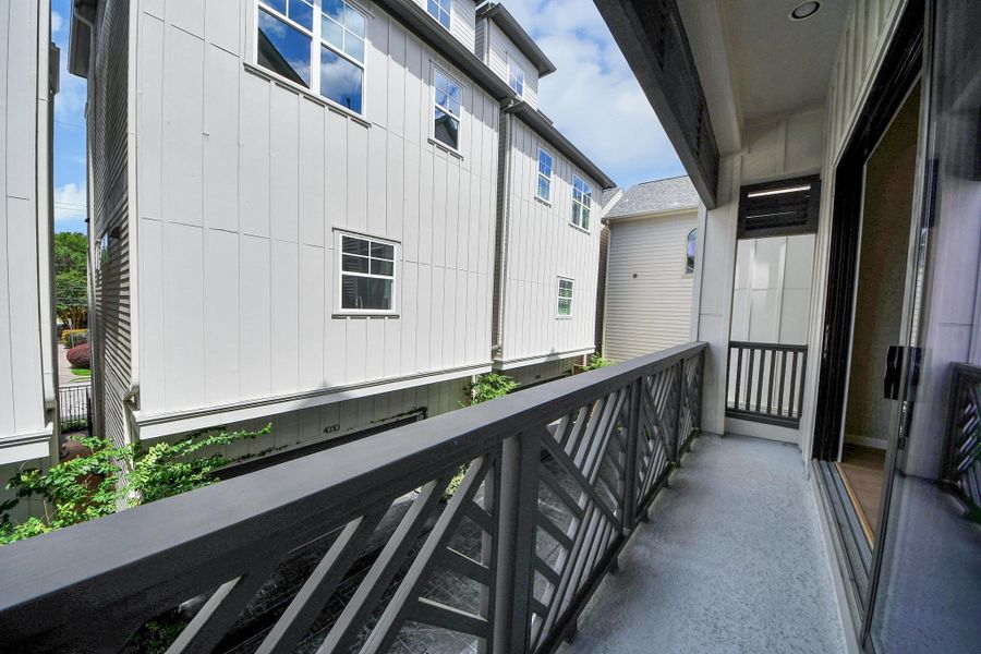 Balcony with open-air views and room for seating. Balcony with open-air views and room for seating.