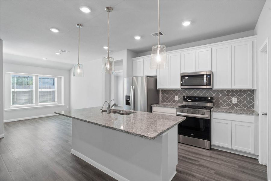 Discover this chef-ready kitchen featuring sleek, shaker-style white cabinetry, white sparkle granite countertops, and a full suite of stainless steel appliances, including an over-the-range microwave and a side-by-side refrigerator. Discover this chef-ready kitchen featuring sleek, shaker-style white cabinetry, white sparkle granite countertops, and a full suite of stainless steel appliances, including an over-the-range microwave and a side-by-side refrigerator.