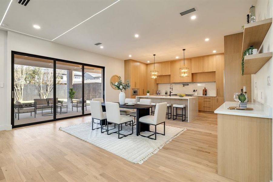 Dining area with light hardwood / wood-style floors and sink