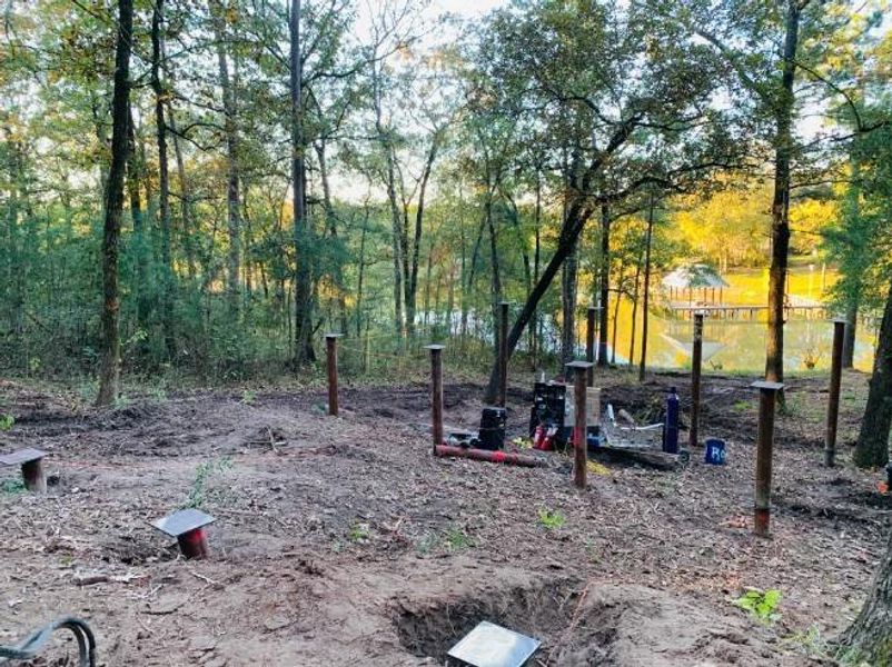 Establishing foundation with 13 steel helical piers that extend 10-15 feet in the ground.