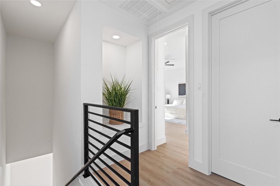 The third-floor landing introduces a built-in display niche, guiding you toward the primary suite & secondary bedroom. The third-floor landing introduces a built-in display niche, guiding you toward the primary suite & secondary bedroom.