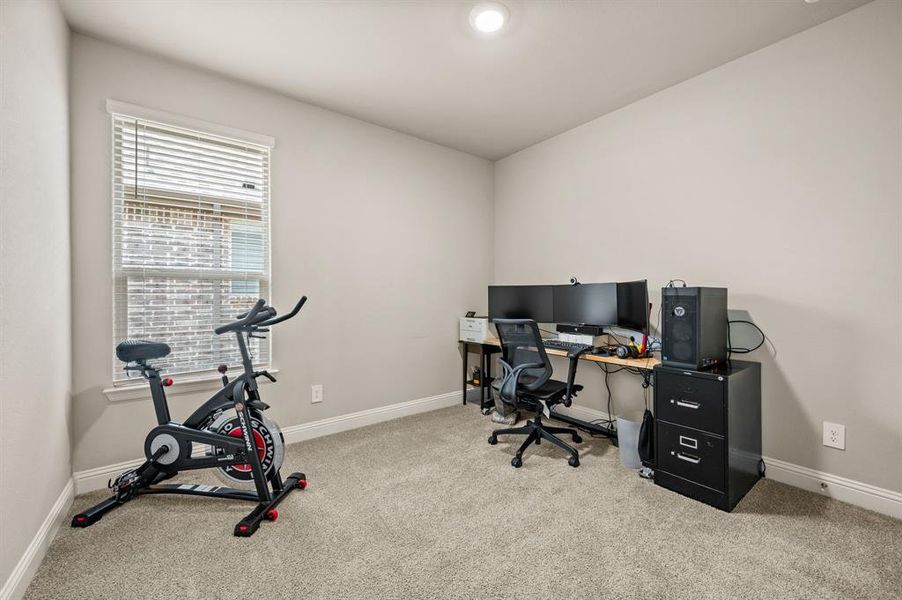ersatile bedroom currently set up as a home office and workout space, ideal for remote work or hobbies.