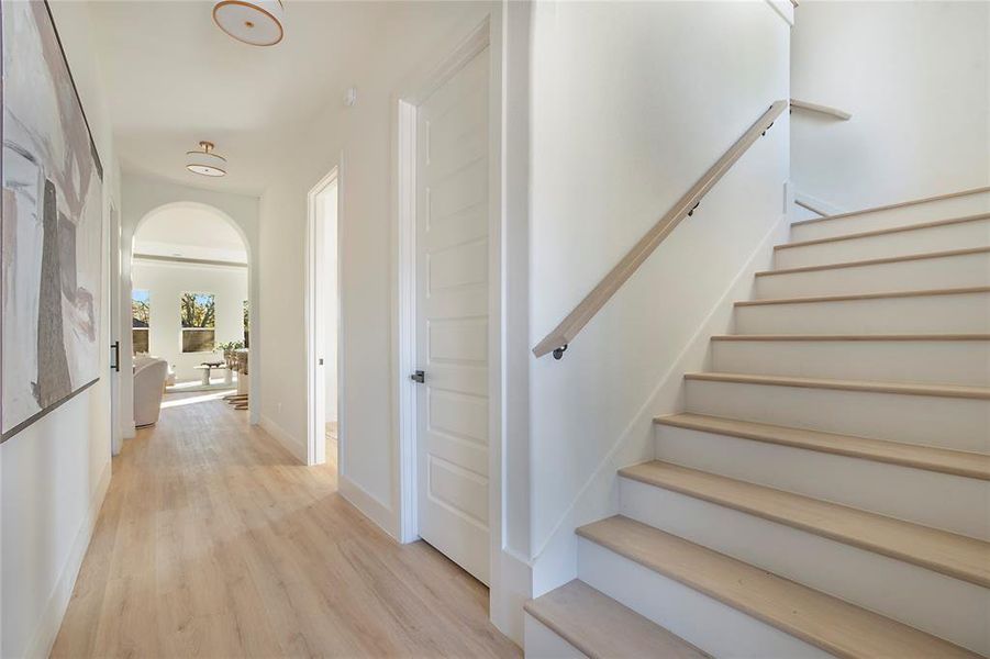 Staircase with wood finished floors and arched walkways Staircase with wood finished floors and arched walkways