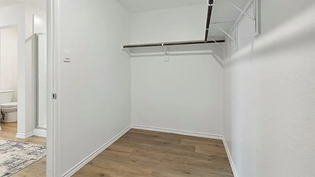 Walk in closet featuring light wood-type flooring Walk in closet featuring light wood-type flooring