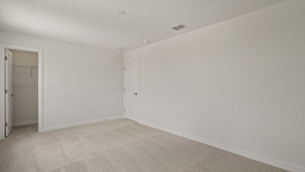 Comfortable second bedroom with roomy walk-in closet—ideal for guests, kids, or a personalized private retreat