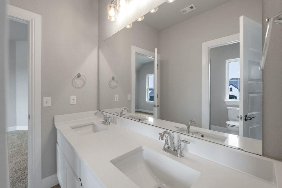 Bathroom with toilet and double vanity Bathroom with toilet and double vanity