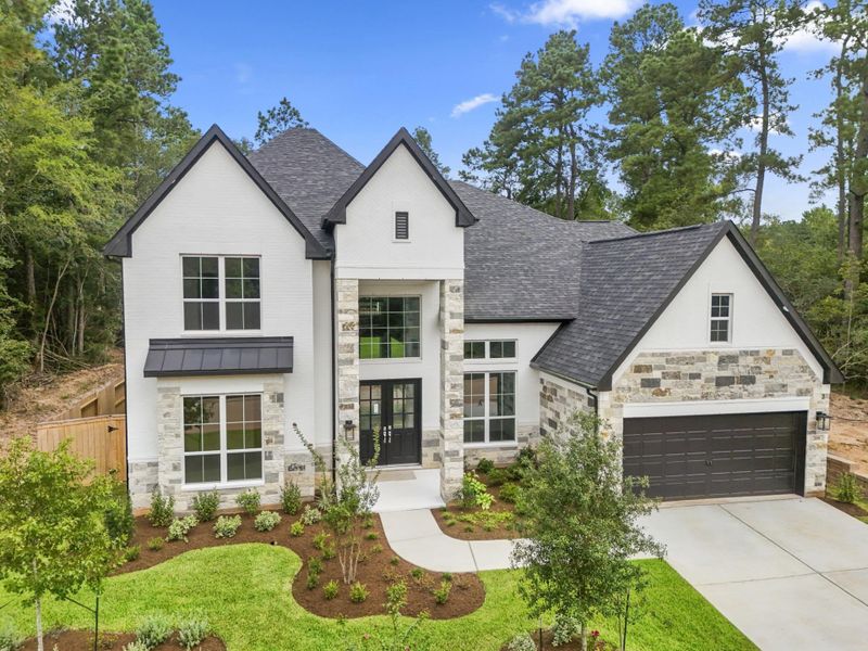 Front exterior of a new home in The Woodlands Hills, Willis, TX, highlighting curb appeal (Image 30). Front exterior of a new home in The Woodlands Hills, Willis, TX, highlighting curb appeal (Image 30).