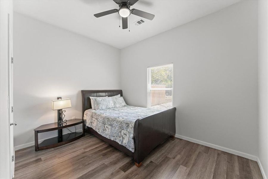 Bedroom with wood finished floors and ceiling fan