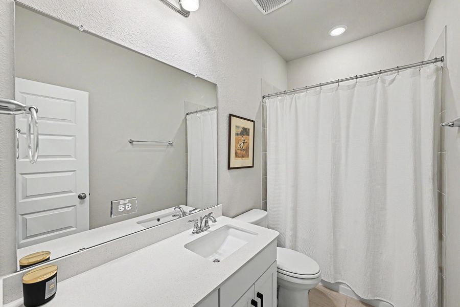 The first-floor full bathroom features a tub/shower combination and is conveniently located adjacent to the second bedroom. The first-floor full bathroom features a tub/shower combination and is conveniently located adjacent to the second bedroom.