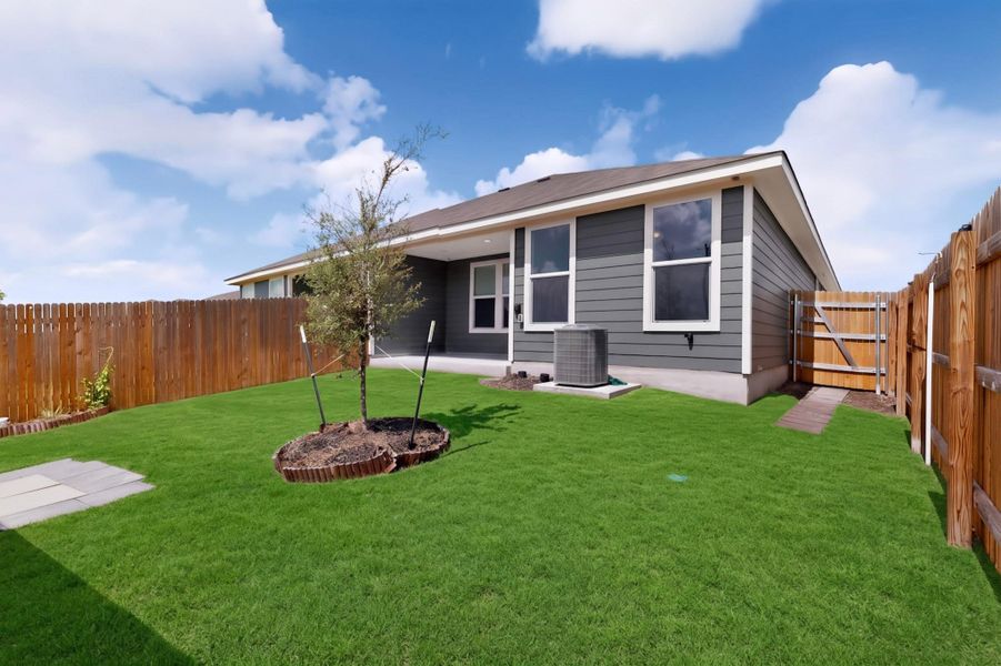 An enclosed grassy yard behind the home provides a private outdoor retreat. An enclosed grassy yard behind the home provides a private outdoor retreat.