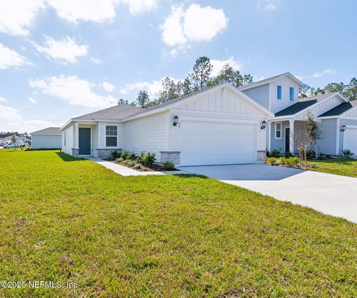 Front exterior of a new home in Flagler Village - Classic Series, Palm Coast, FL, highlighting curb appeal (Image 20).