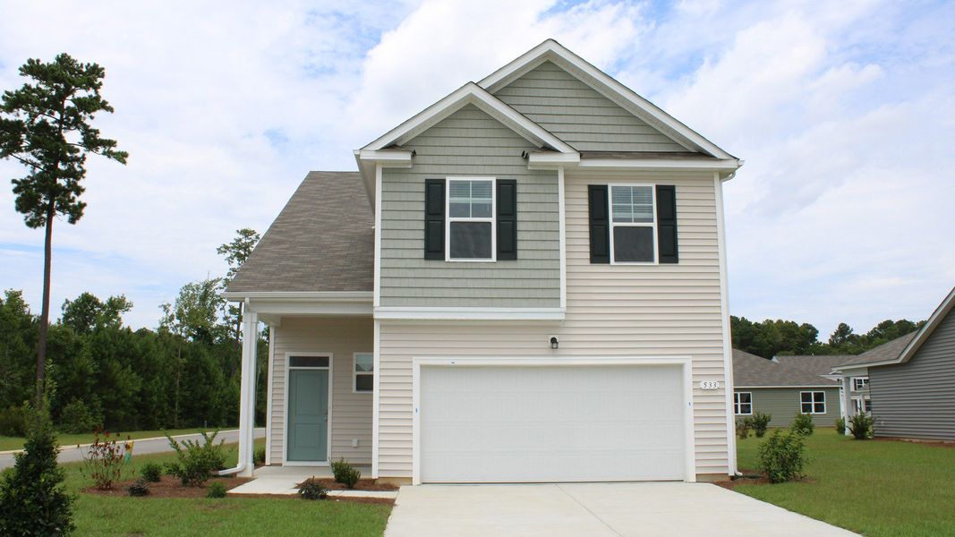Front exterior of a new home in Heritage Crossing, Conway, SC, highlighting curb appeal (Image 1).