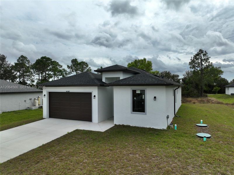 Front exterior of a new home in , Lehigh Acres, FL, highlighting curb appeal (Image 23). Front exterior of a new home in , Lehigh Acres, FL, highlighting curb appeal (Image 23).