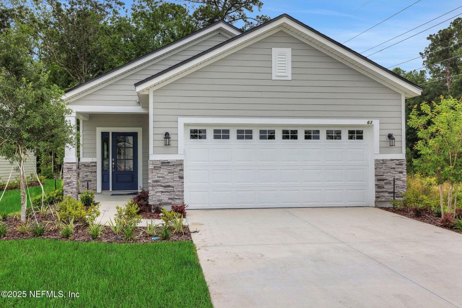 Front exterior of a new home in TrailMark, St. Augustine, FL, highlighting curb appeal (Image 21). Front exterior of a new home in TrailMark, St. Augustine, FL, highlighting curb appeal (Image 21).
