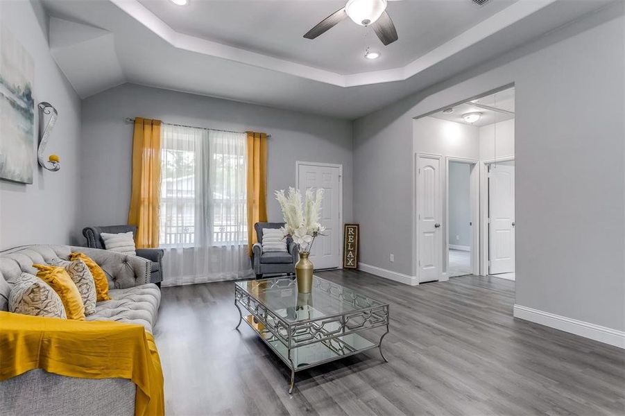 Living room with hardwood / wood-style flooring and ceiling fan