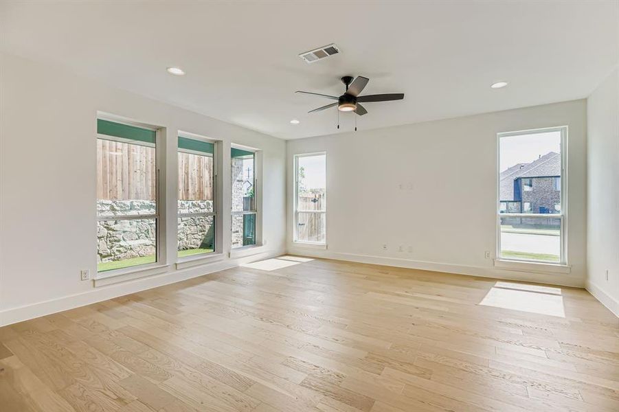 Spare room featuring a ceiling fan, light wood-type flooring, and recessed lighting