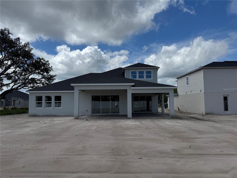 Front exterior of a new home in Solace at Corner Lake, Orlando, FL, highlighting curb appeal (Image 27).