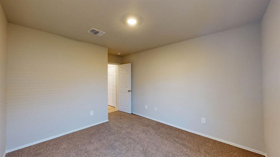 Spare room with carpet and baseboards
